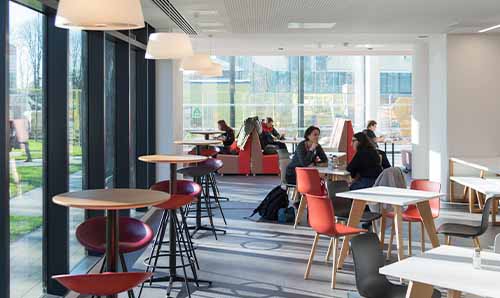 The inside of Cafe 65 with people sitting down at Alliance Manchester Business School
