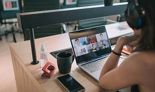 A virtual event on a laptop seeing attendees on the screen