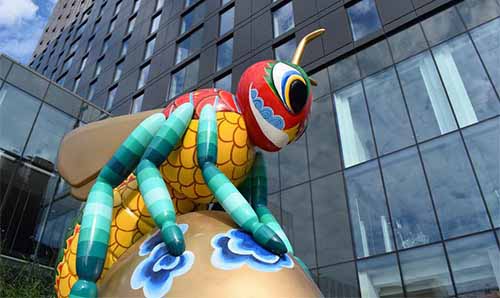 The front of the Hyatt Regency Hotel with the Beejing sculpture in the foreground